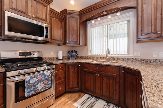 787 S 2nd W, Preston, ID 83263 - kitchen featuring light wood-style flooring, a sink, light stone counters, and appliances with stainless steel finishes