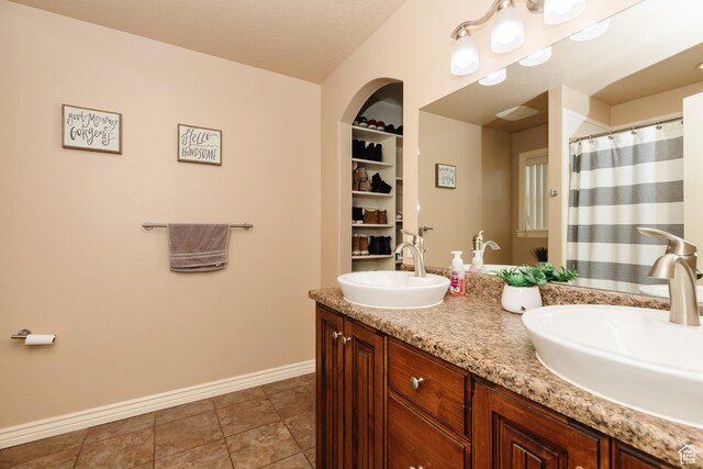 787 S 2nd W, Preston, ID 83263 - full bathroom featuring double vanity, baseboards, a sink, and tile patterned flooring