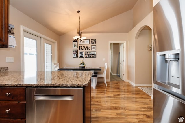 787 S 2nd W, Preston, ID 83263 - kitchen with vaulted ceiling, a notable chandelier, a peninsula, light wood-type flooring, and stainless steel refrigerator with ice dispenser