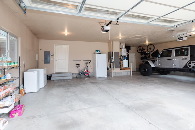787 S 2nd W, Preston, ID 83263 - garage with electric panel, a garage door opener, fridge, and freestanding refrigerator