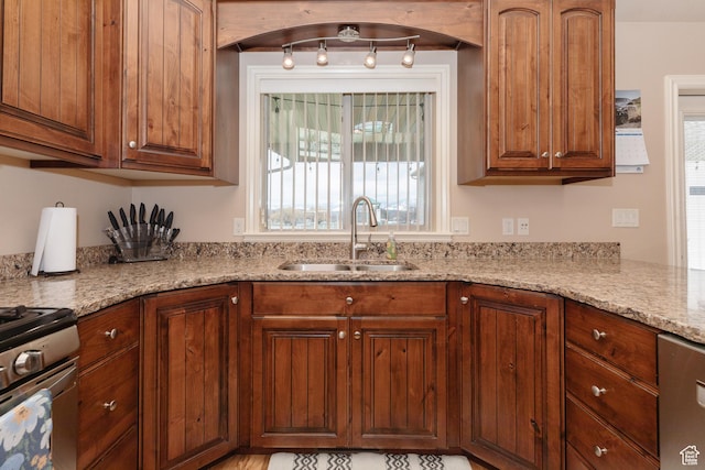 787 S 2nd W, Preston, ID 83263 - kitchen featuring gas range, light stone countertops, a sink, and brown cabinetry