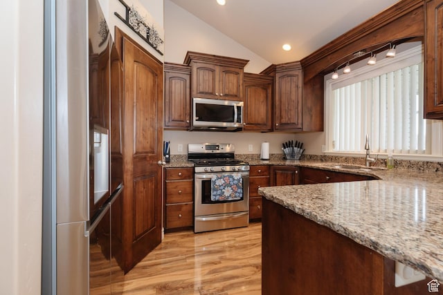787 S 2nd W, Preston, ID 83263 - kitchen featuring lofted ceiling, light stone countertops, a sink, and stainless steel appliances