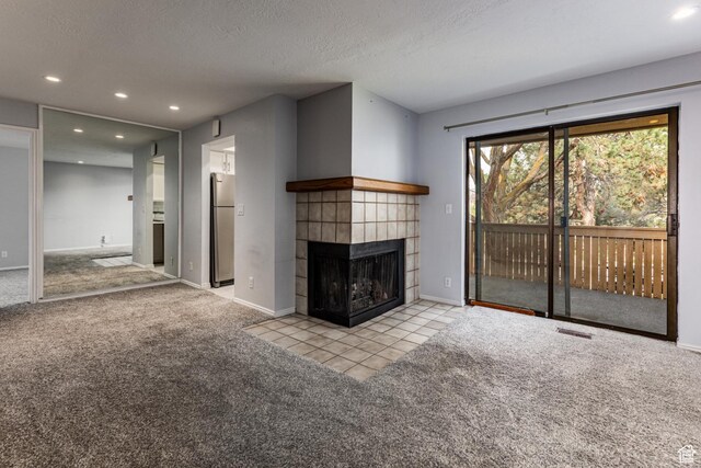 615 W Jefferson Pl, Sandy, UT 84070 - unfurnished living room featuring a textured ceiling, carpet, baseboards, recessed lighting, and a tiled fireplace