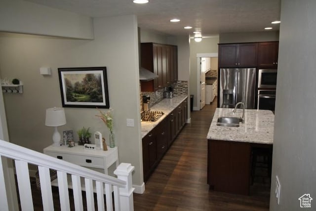 987 W 880 N, American Fork, UT 84003 - kitchen with decorative backsplash, appliances with stainless steel finishes, dark brown cabinetry, dark wood-type flooring, and a sink