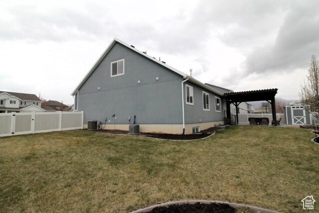 987 W 880 N, American Fork, UT 84003 - view of home's exterior featuring a lawn, central AC unit, and a fenced backyard