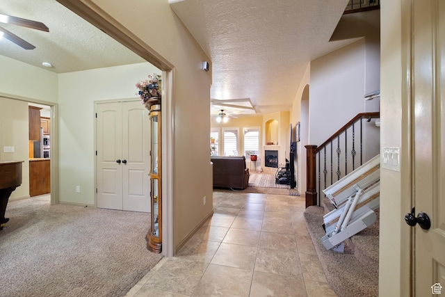 931 E Bramble Way, Washington, UT 84780 - interior space featuring stairs, a textured ceiling, light tile patterned floors, light colored carpet, and arched walkways