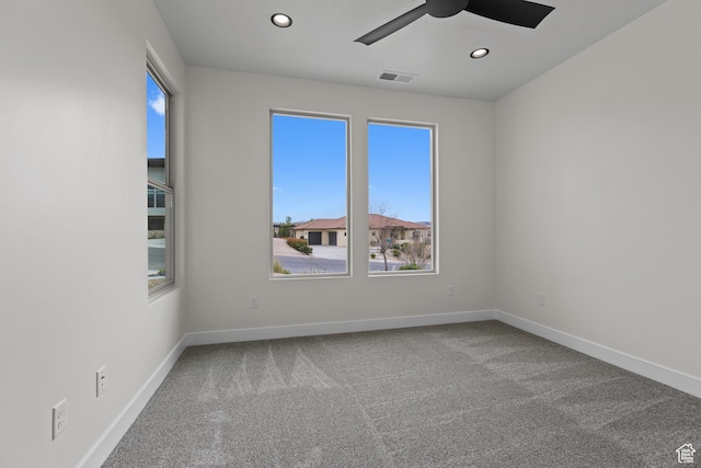 spare room featuring baseboards, visible vents, ceiling fan, and carpet floors