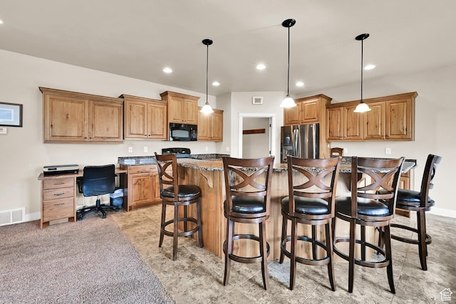 3182 N 1350 W, Pleasant View, UT 84414 - kitchen featuring black microwave, stainless steel fridge, a kitchen bar, brown cabinetry, and a center island