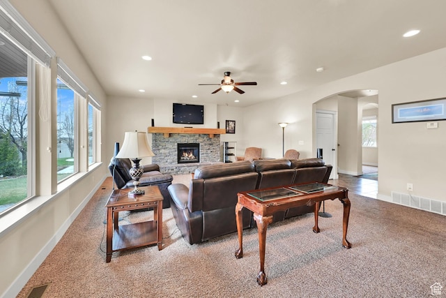 3182 N 1350 W, Pleasant View, UT 84414 - living room featuring arched walkways, light colored carpet, recessed lighting, a ceiling fan, and a fireplace