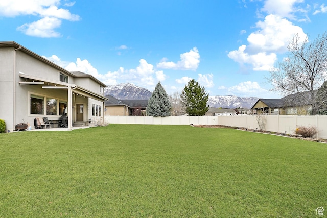 3182 N 1350 W, Pleasant View, UT 84414 - fenced backyard featuring a mountain view and a patio area