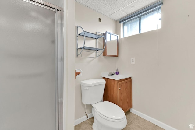 full bathroom with baseboards, toilet, tile patterned floors, and a shower stall