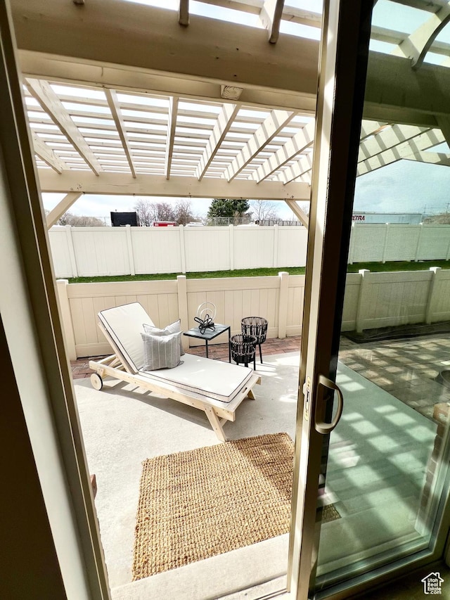 view of patio with a pergola and fence
