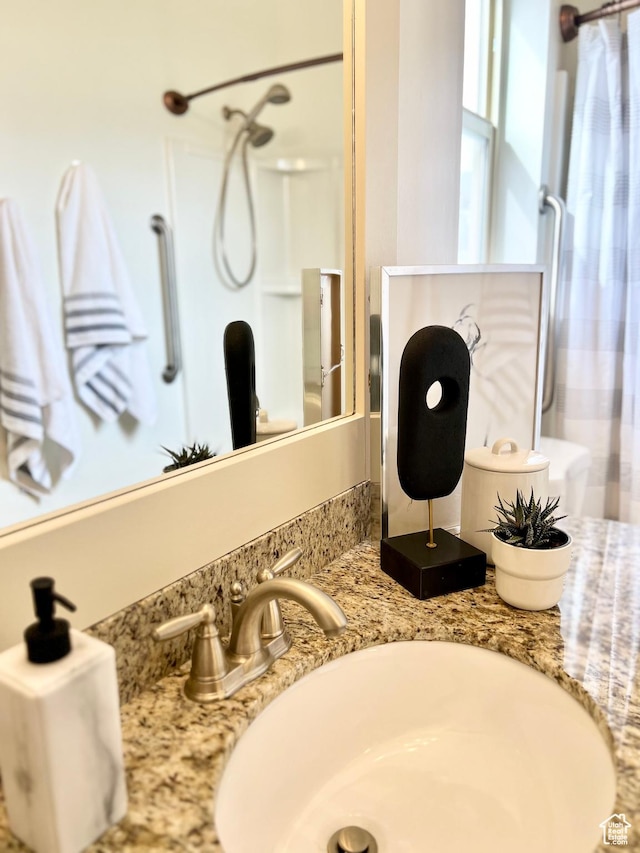 full bath with shower / bathtub combination with curtain and a sink