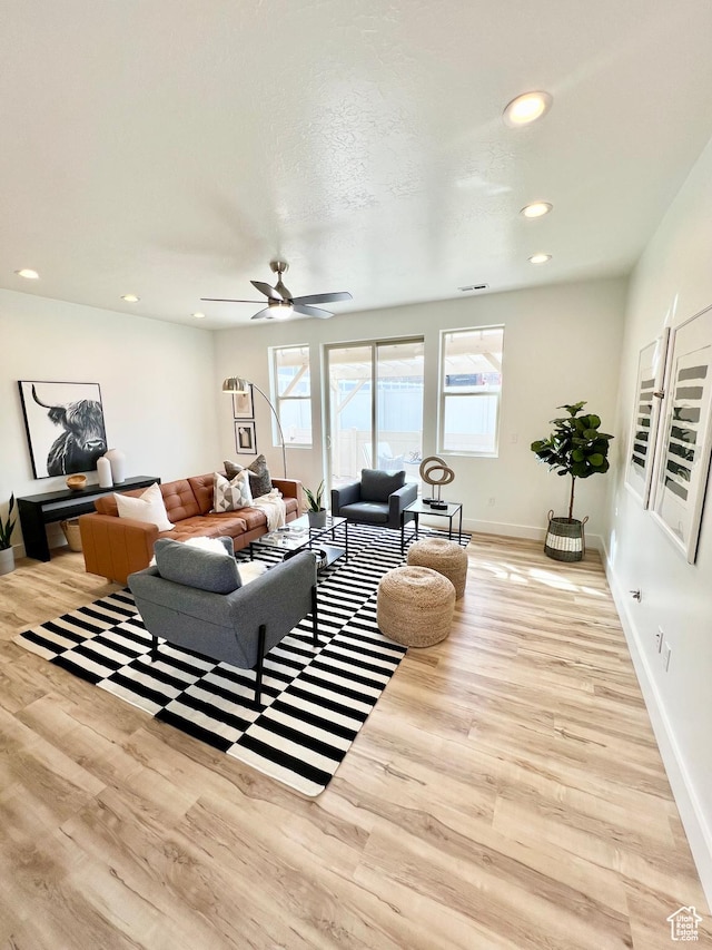 living area featuring wood finished floors, baseboards, a ceiling fan, and recessed lighting