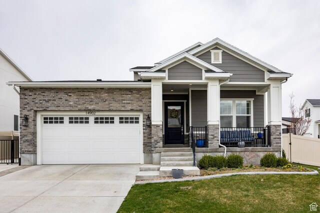 14902 S Fawley Ln, Herriman, UT 84096 - craftsman-style home featuring covered porch, driveway, a front yard, fence, and an attached garage