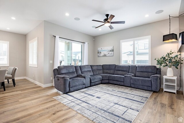 14902 S Fawley Ln, Herriman, UT 84096 - living room featuring light wood-style floors, a ceiling fan, and a wealth of natural light