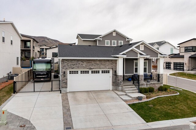 14902 S Fawley Ln, Herriman, UT 84096 - craftsman inspired home featuring a porch, a gate, brick siding, concrete driveway, and a shingled roof