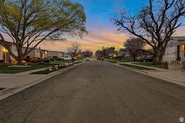 view of street featuring sidewalks, curbs, and a residential view