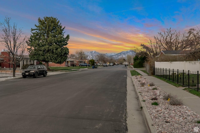 view of street featuring sidewalks, curbs, and a mountain view