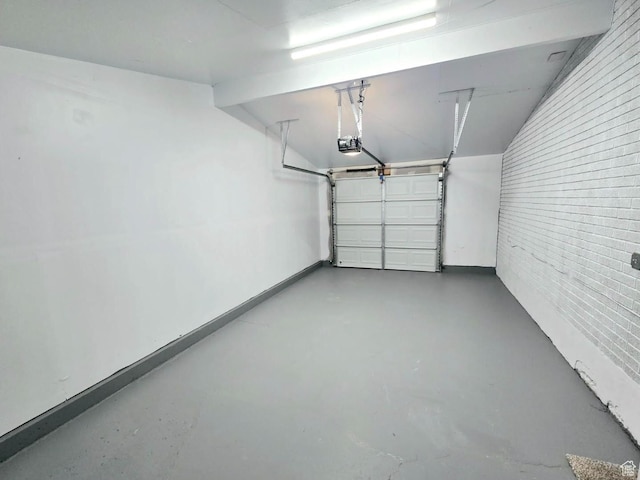 garage with a garage door opener and baseboards
