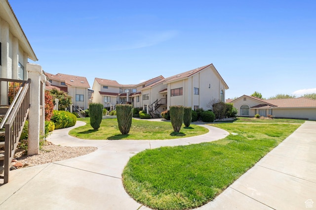 view of property's community featuring a residential view and a yard