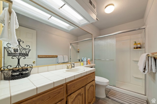 full bath featuring a shower stall, visible vents, toilet, and vanity