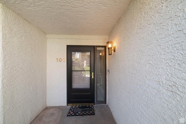 entrance to property featuring stucco siding