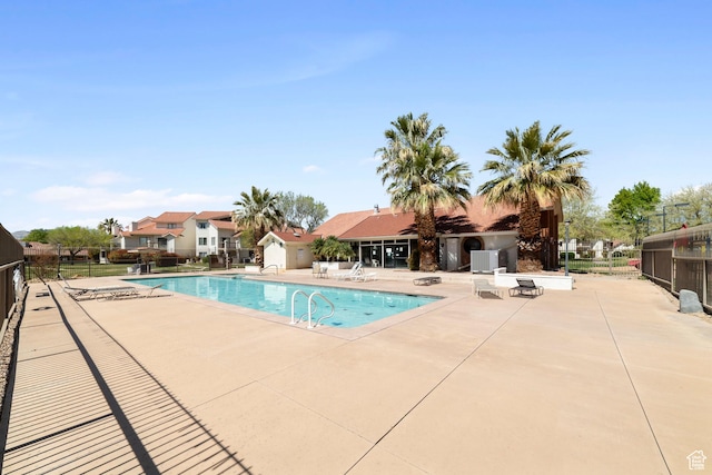 community pool featuring a patio and fence