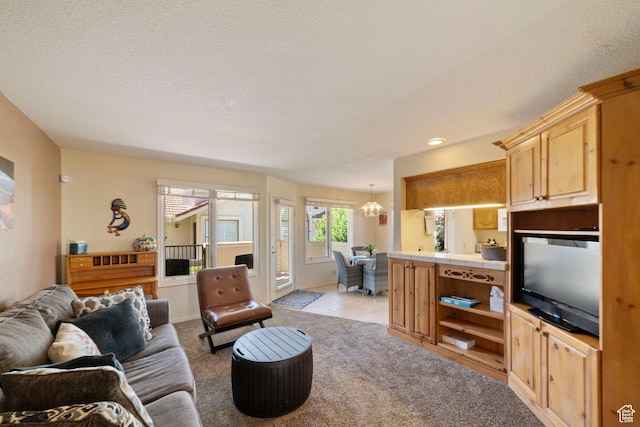 living room with light carpet, light tile patterned floors, and a textured ceiling