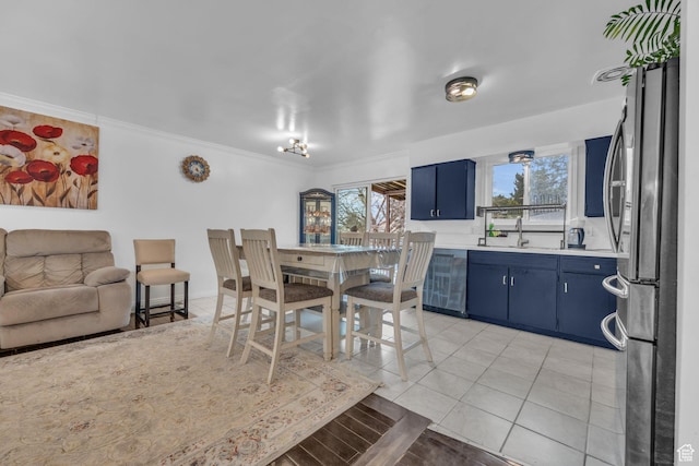 dining area with light tile patterned flooring and crown molding