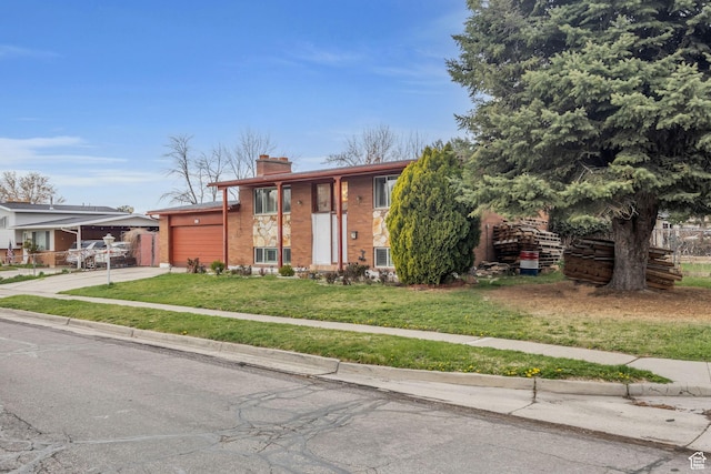 view of front facade with an attached garage, a chimney, concrete driveway, brick siding, and a front lawn