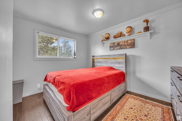 bedroom featuring hardwood / wood-style floors, ornamental molding, and baseboards