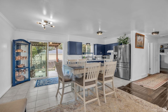 dining space featuring light tile patterned flooring, crown molding, baseboards, and visible vents