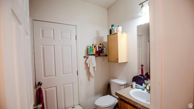 bathroom featuring toilet and vanity