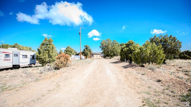 view of road with dirt driveway