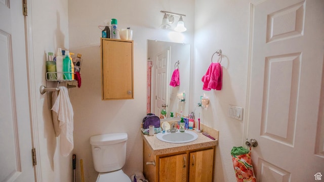 bathroom featuring toilet and vanity