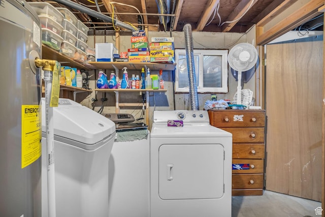 laundry area featuring water heater, washing machine and dryer, and laundry area