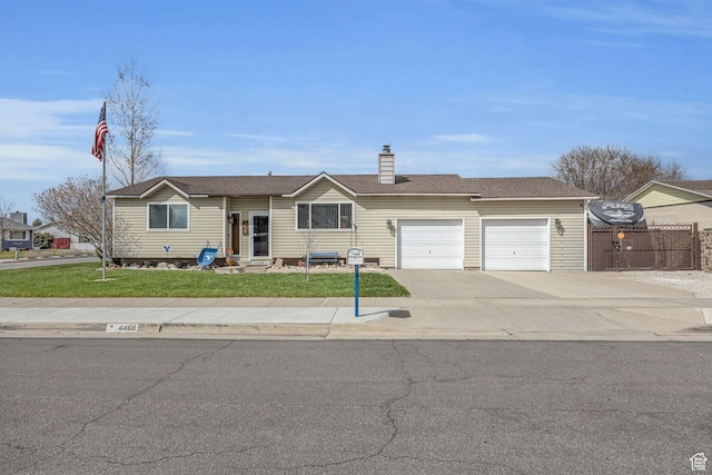 single story home with concrete driveway, fence, an attached garage, a front yard, and a chimney