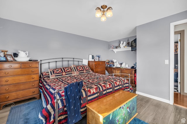 bedroom featuring baseboards and wood finished floors