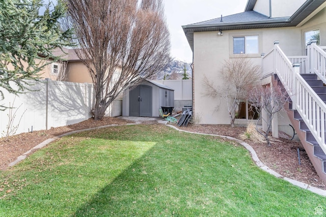 1255 W 3300 N, Pleasant View, UT 84414 - view of yard featuring an outdoor structure, stairs, a fenced backyard, and a storage shed