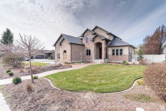 1255 W 3300 N, Pleasant View, UT 84414 - view of front of property with a front lawn, stucco siding, fence, and brick siding