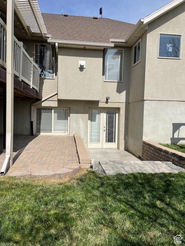 rear view of property with stucco siding and a patio area