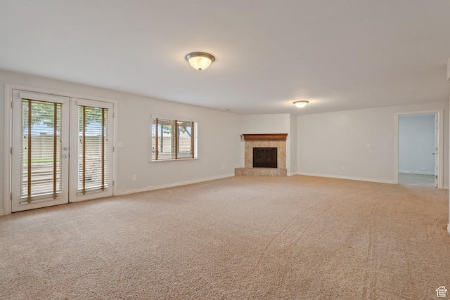 2711 N Deer Meadow Dr, Lehi, UT 84043 - unfurnished living room featuring light carpet, baseboards, and a tiled fireplace