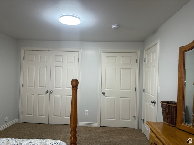 unfurnished bedroom featuring carpet floors and baseboards