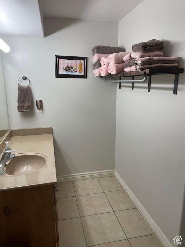 bathroom with tile patterned flooring, vanity, and baseboards