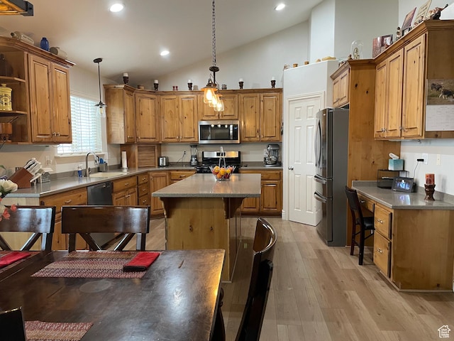 kitchen featuring a sink, open shelves, a kitchen island, appliances with stainless steel finishes, and brown cabinets