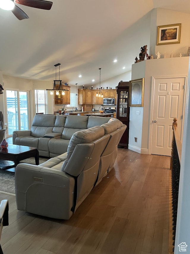living room featuring dark wood-type flooring, vaulted ceiling, recessed lighting, and a ceiling fan