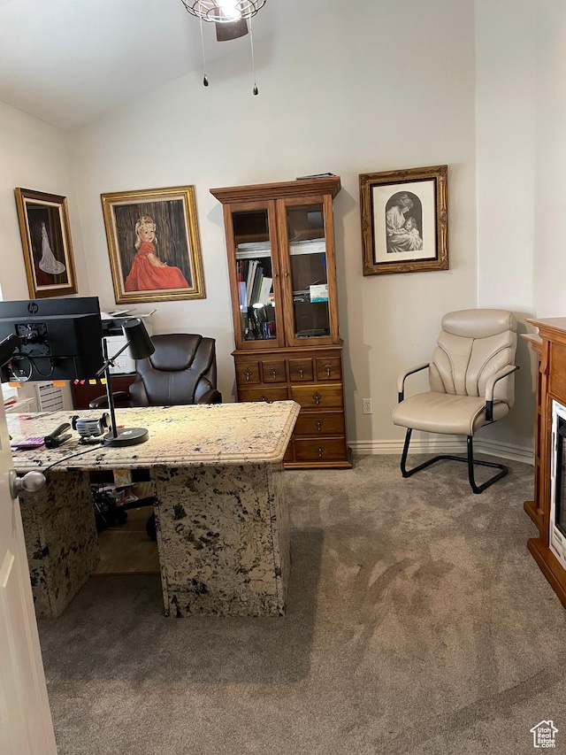 office area with baseboards, lofted ceiling, ceiling fan, and carpet flooring