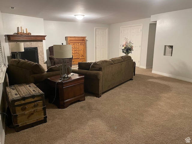 living room with baseboards, a fireplace, and carpet