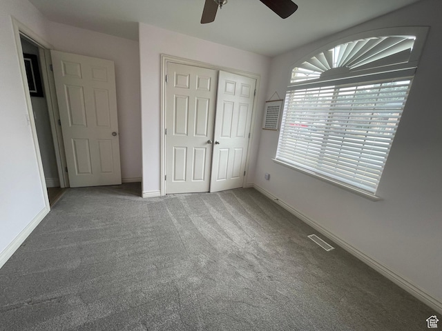 unfurnished bedroom featuring carpet flooring, a closet, baseboards, and visible vents